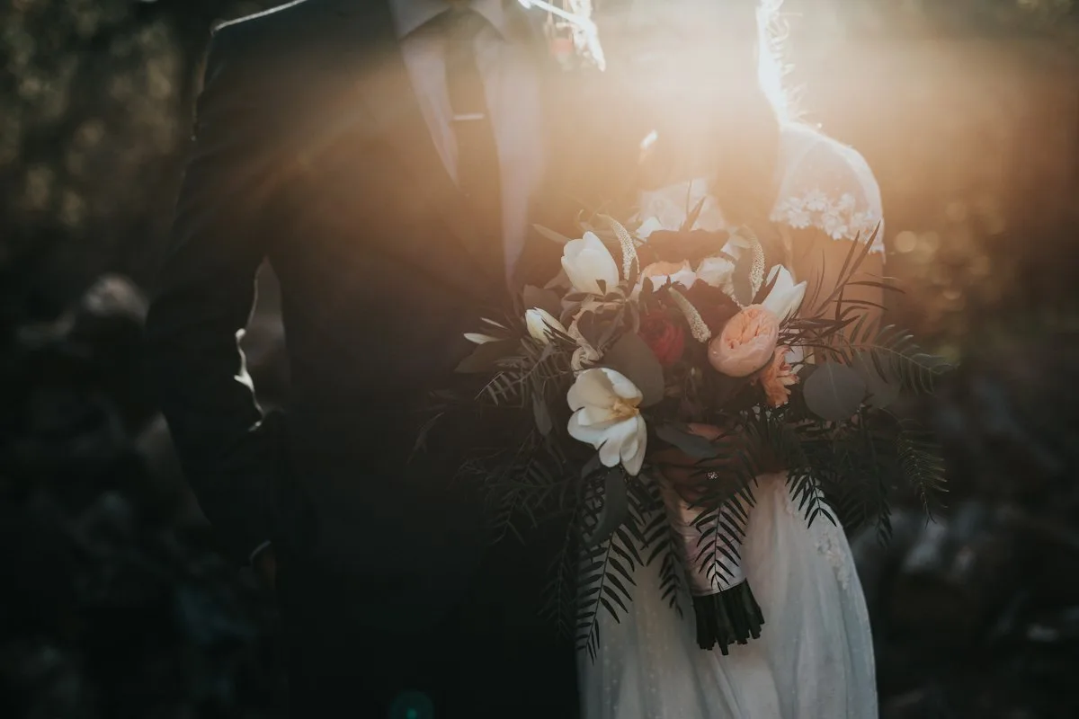 A couple holding a wedding bouquet · illustrative photography